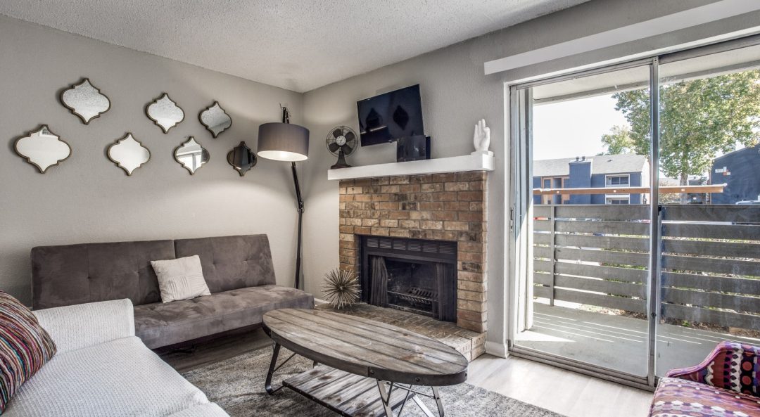 a living room with a fireplace and a couch at The Preslee